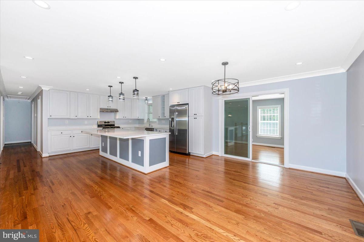 Empty room, Interior, Kitchen, Pendant Lights, Recessed Lighting, Stainless Steel Appliances, Wood Texture Flooring
