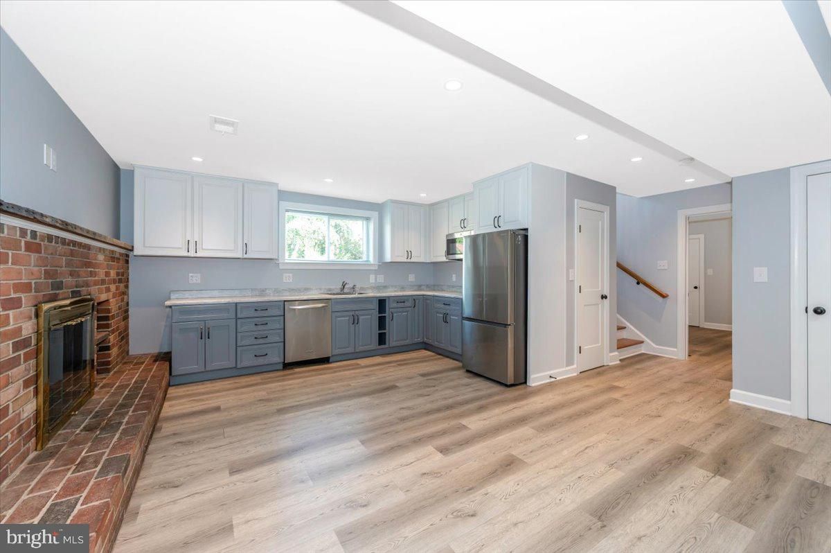 Fireplace, Interior, Kitchen, Recessed Lighting, Stainless Steel Appliances, Stone Walls, Wood Texture Flooring