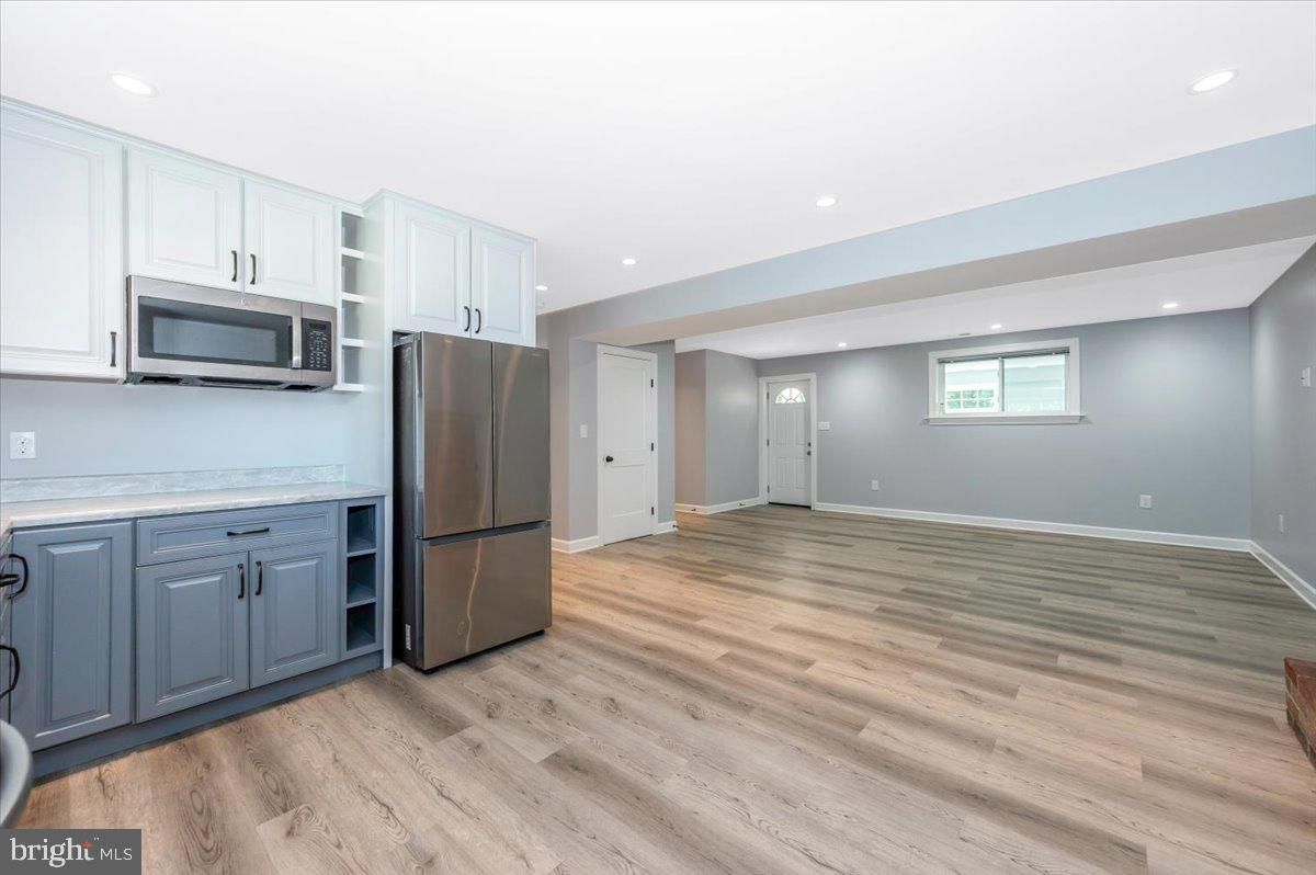 Empty room, Interior, Kitchen, Recessed Lighting, Stainless Steel Appliances, Wood Texture Flooring