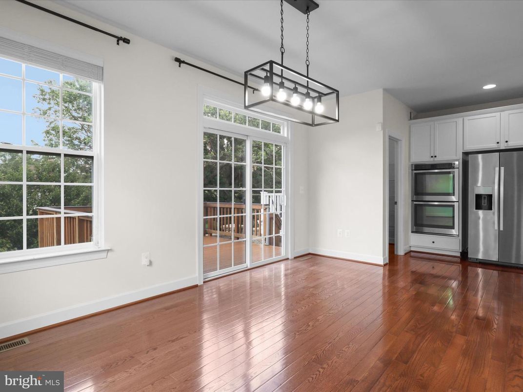 Empty room, Interior, Kitchen, Pendant Lights, Recessed Lighting, Stainless Steel Appliances, Wood Texture Flooring