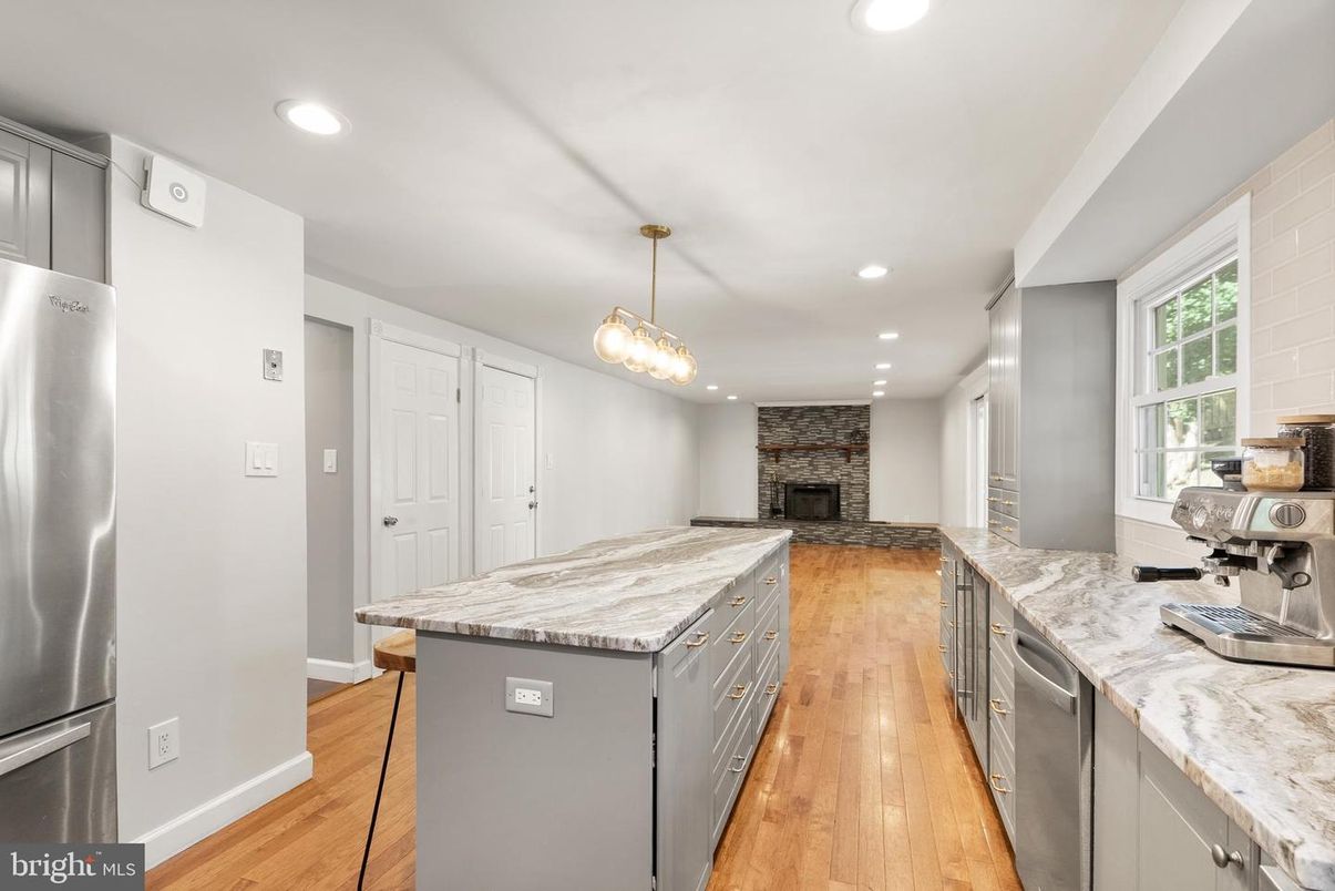 Fireplace, Interior, Kitchen, Pendant Lights, Recessed Lighting, Stainless Steel Appliances, Stone Walls, Wood Texture Flooring