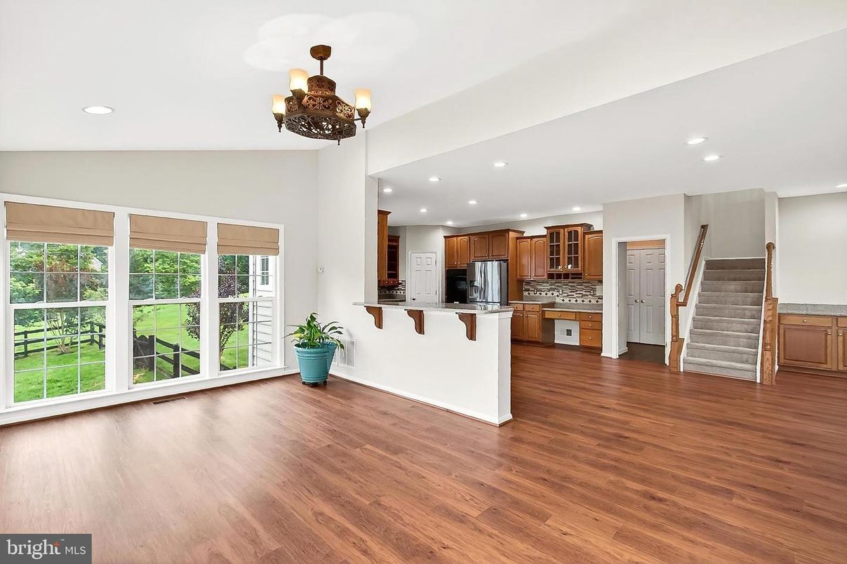 Chandelier, Empty room, Interior, Kitchen, Recessed Lighting, Stainless Steel Appliances, Wood Texture Flooring
