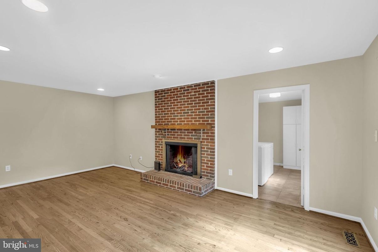 Empty room, Fireplace, Interior, Recessed Lighting, Stone Walls, Wood Texture Flooring