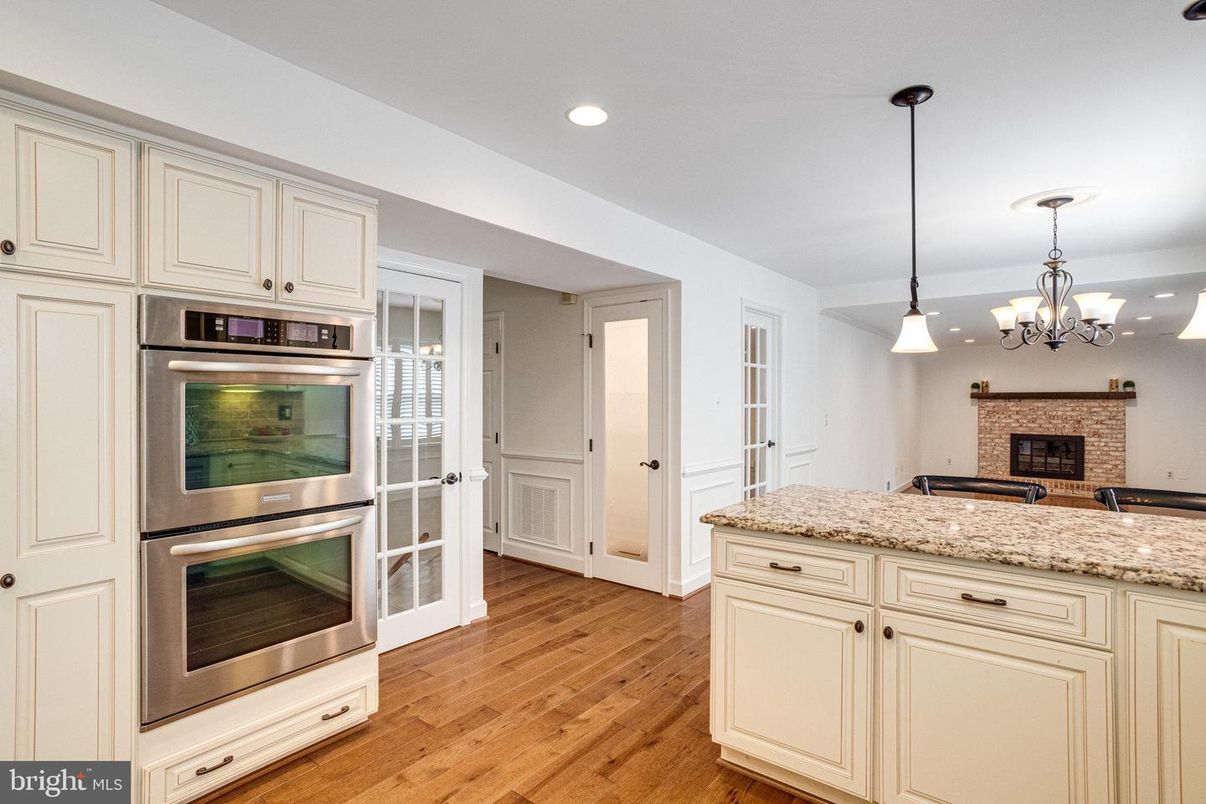 Chandelier, Fireplace, Interior, Kitchen, Pendant Lights, Recessed Lighting, Stainless Steel Appliances, Wood Texture Flooring