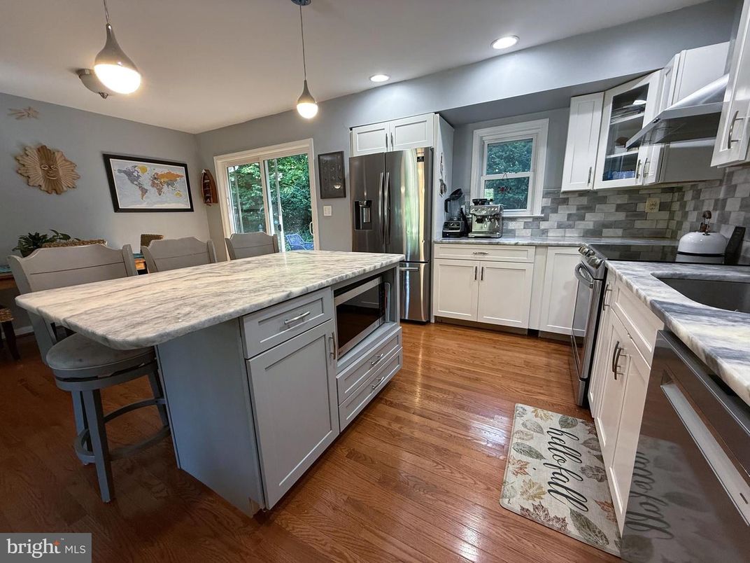 Dining room, Interior, Kitchen, Pendant Lights, Recessed Lighting, Stainless Steel Appliances, Wood Texture Flooring