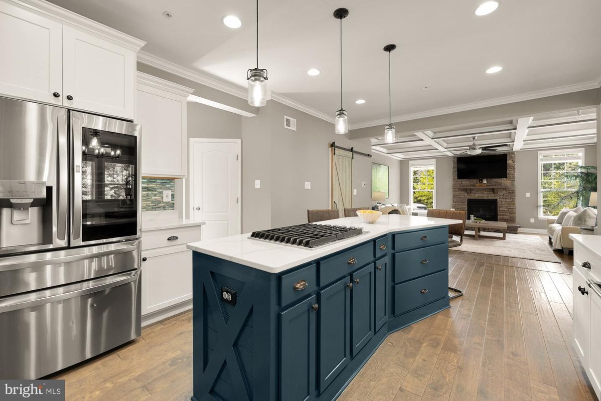 Fireplace, Interior, Kitchen, Living room, Pendant Lights, Recessed Lighting, Stainless Steel Appliances, Stone Walls, Wood Texture Flooring