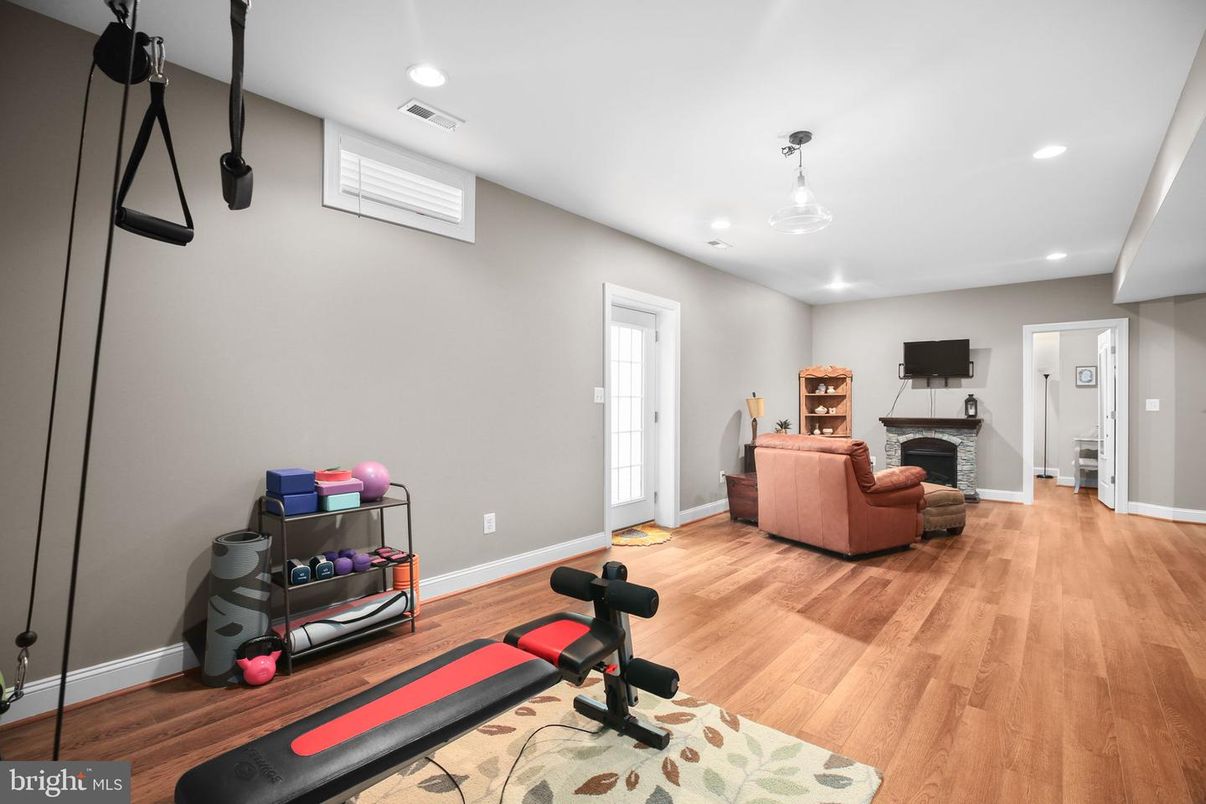 Fireplace, Fitness Equipment, Interior, Living room, Recessed Lighting, Wood Texture Flooring