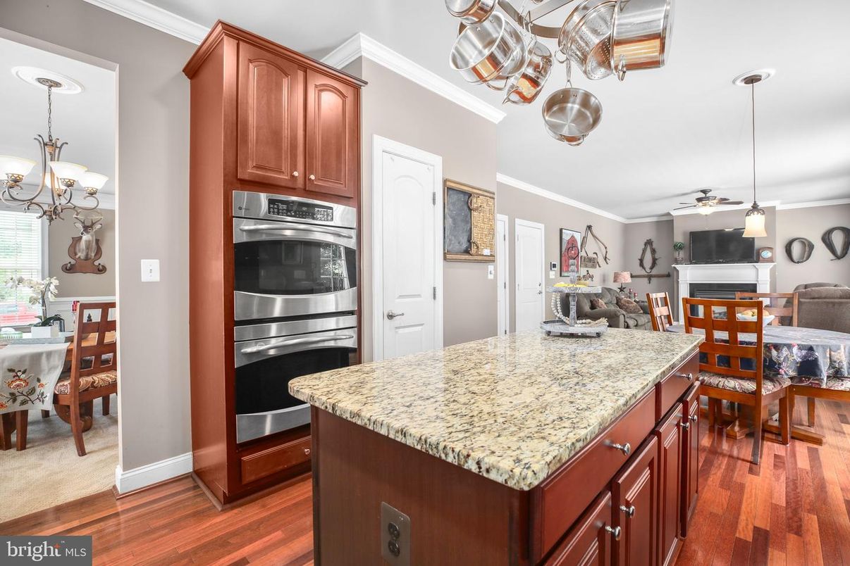 Chandelier, Dining room, Interior, Kitchen, Pendant Lights, Stainless Steel Appliances, Wood Texture Flooring