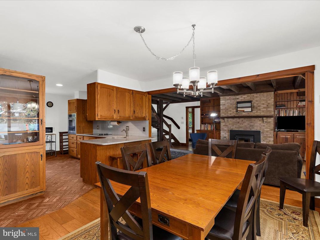 Chandelier, Dining room, Fireplace, Interior, Kitchen, Living room, Recessed Lighting, Stone Walls, Wood Texture Flooring