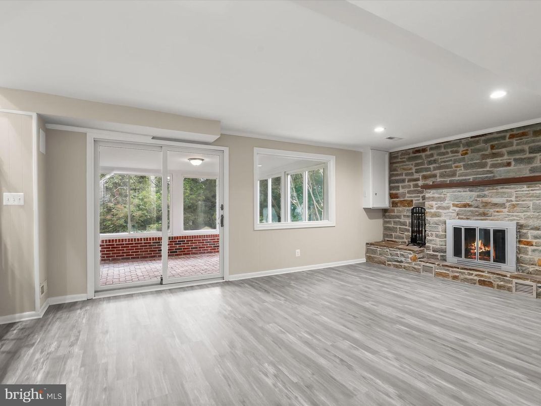 Empty room, Fireplace, Interior, Recessed Lighting, Stone Walls, Wood Texture Flooring