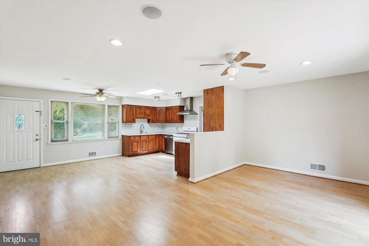 Empty room, Interior, Kitchen, Recessed Lighting, Stainless Steel Appliances, Wood Texture Flooring