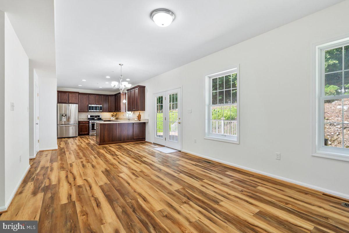 Empty room, Interior, Kitchen, Pendant Lights, Recessed Lighting, Stainless Steel Appliances, Wood Texture Flooring