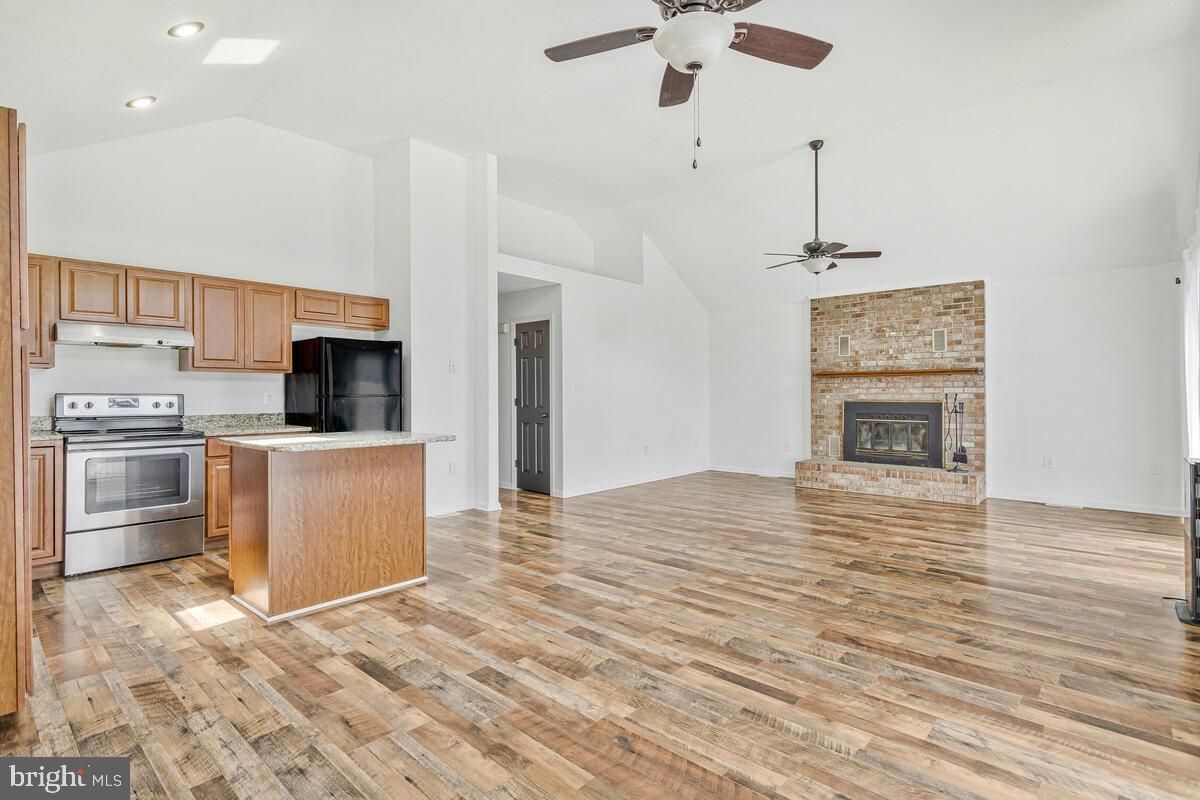 Empty room, Fireplace, Interior, Kitchen, Recessed Lighting, Stone Walls, Wood Texture Flooring