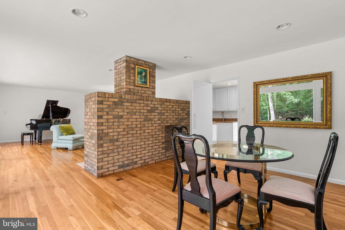 Dining room, Fireplace, Interior, Piano, Recessed Lighting, Stone Walls, Wood Texture Flooring