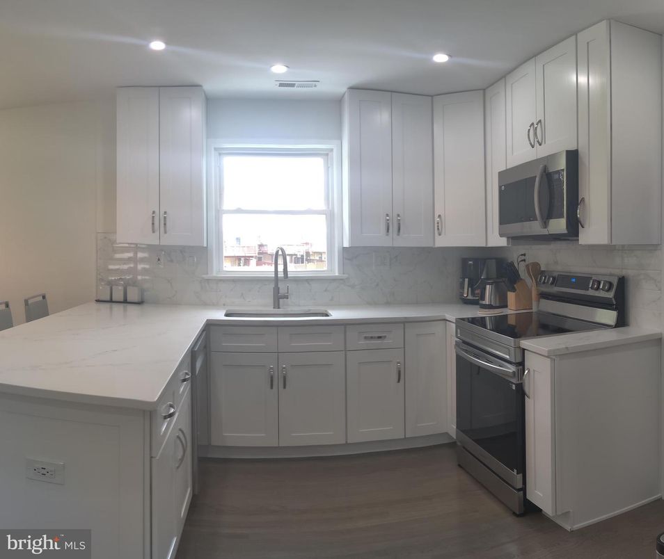 Interior, Kitchen, Marble Walls, Recessed Lighting, Stainless Steel Appliances, Wood Texture Flooring