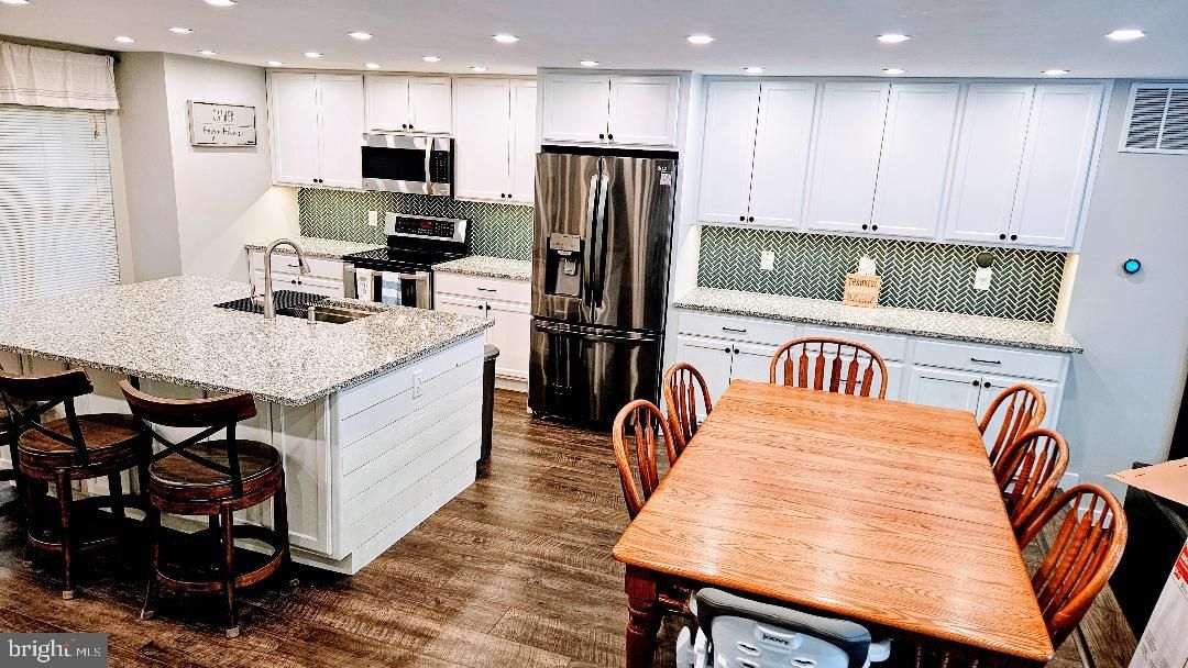 Dining room, Interior, Kitchen, Recessed Lighting, Stainless Steel Appliances, Wood Texture Flooring