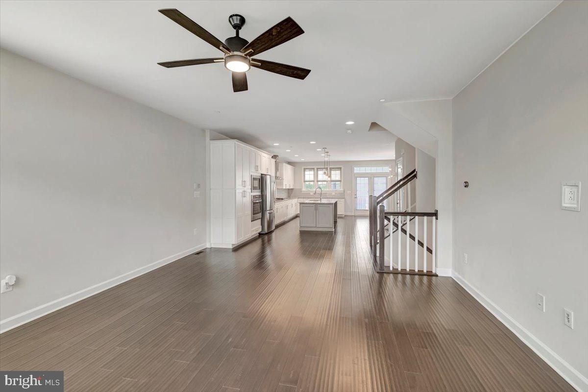 Empty room, Interior, Kitchen, Pendant Lights, Recessed Lighting, Stainless Steel Appliances, Wood Texture Flooring
