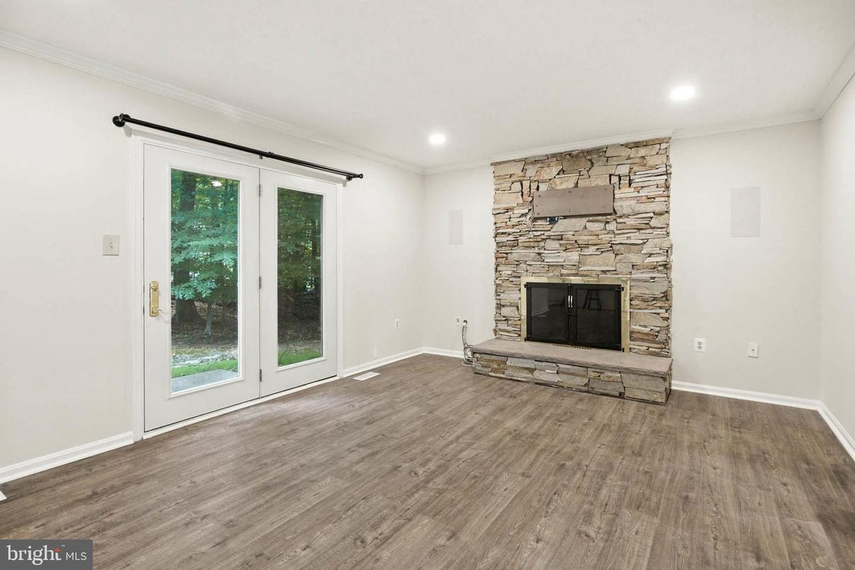 Empty room, Fireplace, Interior, Recessed Lighting, Stone Walls, Wood Texture Flooring