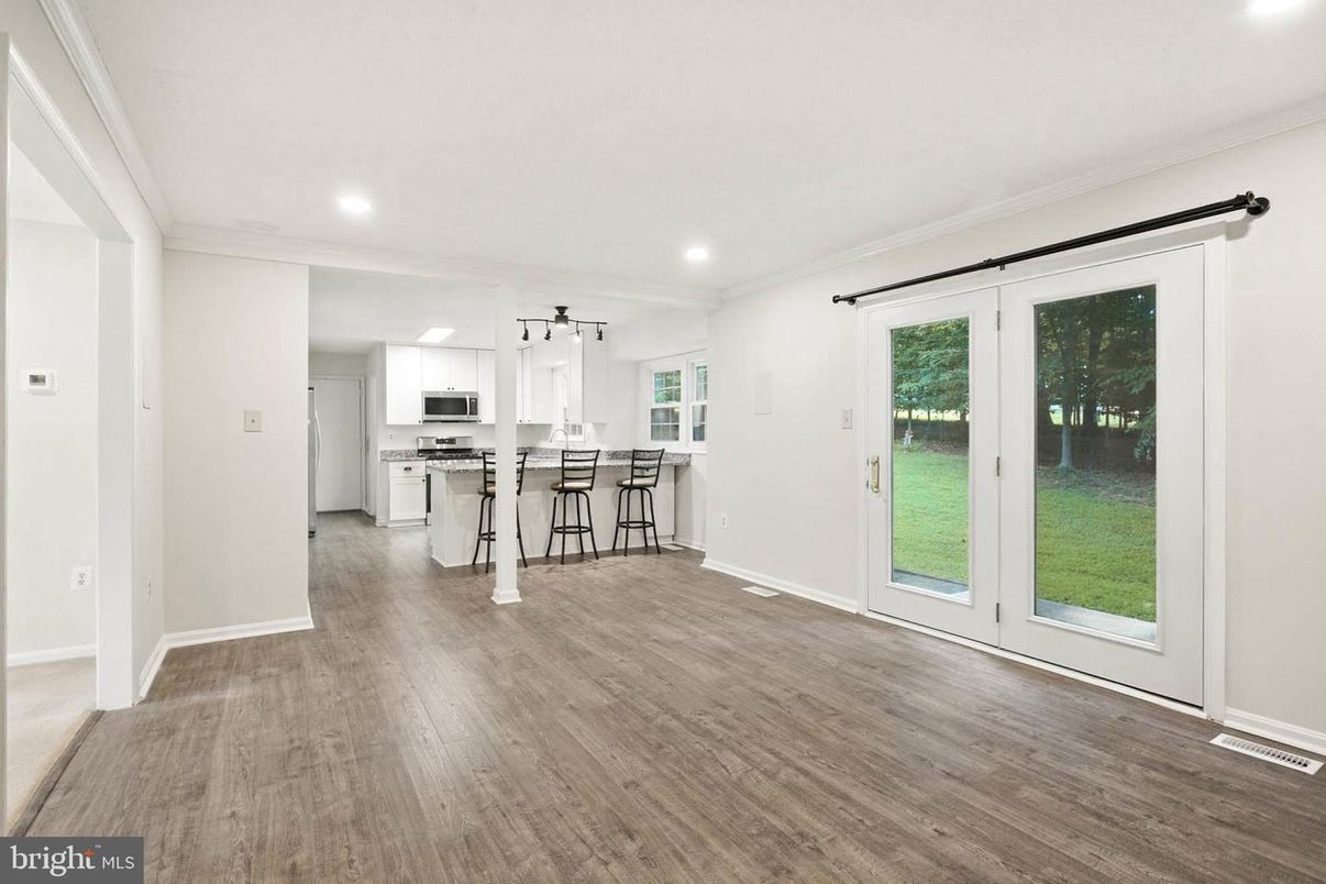Empty room, Interior, Kitchen, Recessed Lighting, Stainless Steel Appliances, Wood Texture Flooring