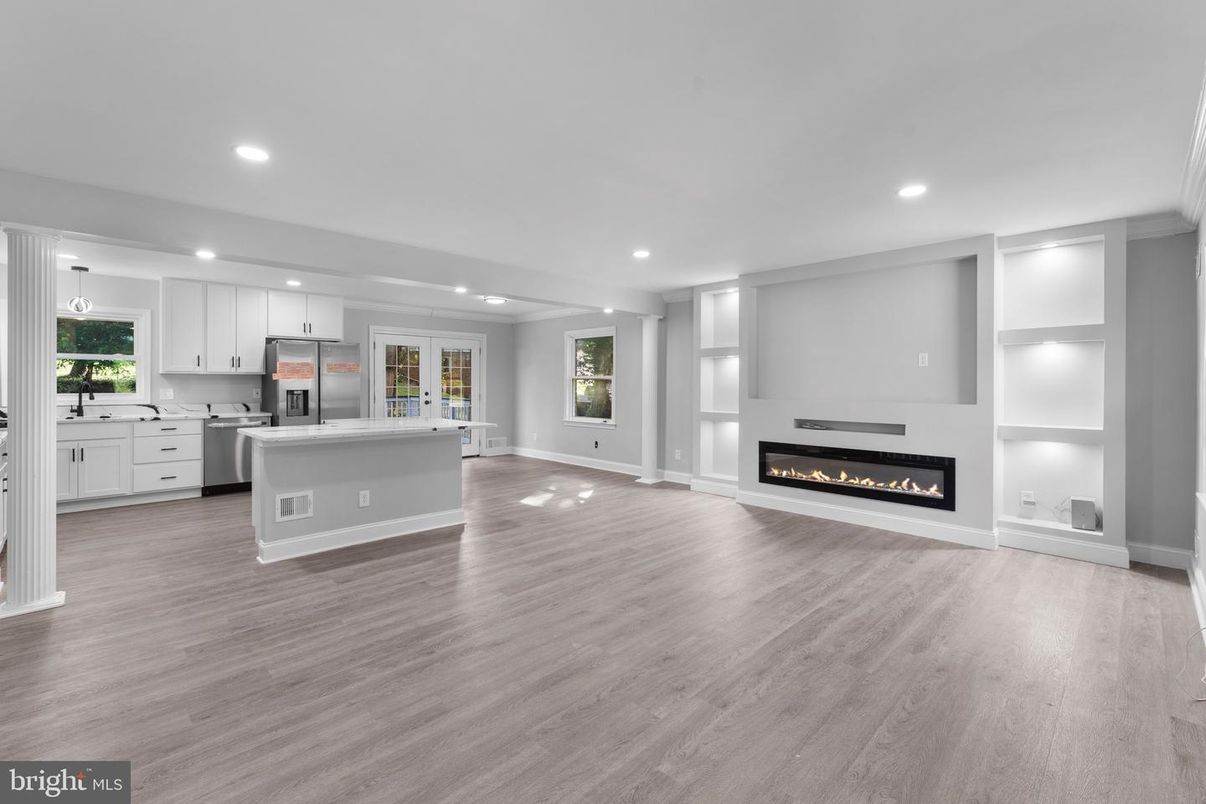 Empty room, Fireplace, Interior, Kitchen, Pendant Lights, Recessed Lighting, Stainless Steel Appliances, Wood Texture Flooring