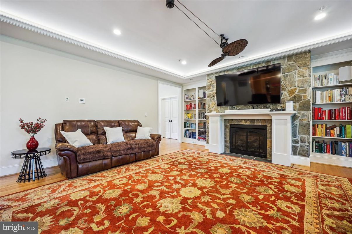 Fireplace, Interior, Living room, Recessed Lighting, Stone Walls, Wood Texture Flooring