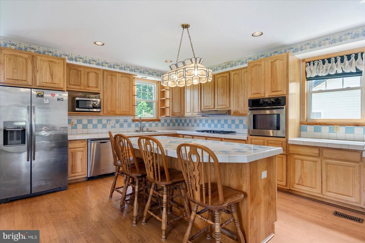 Interior, Kitchen, Pendant Lights, Recessed Lighting, Stainless Steel Appliances, Tile Countertops, Wood Texture Flooring