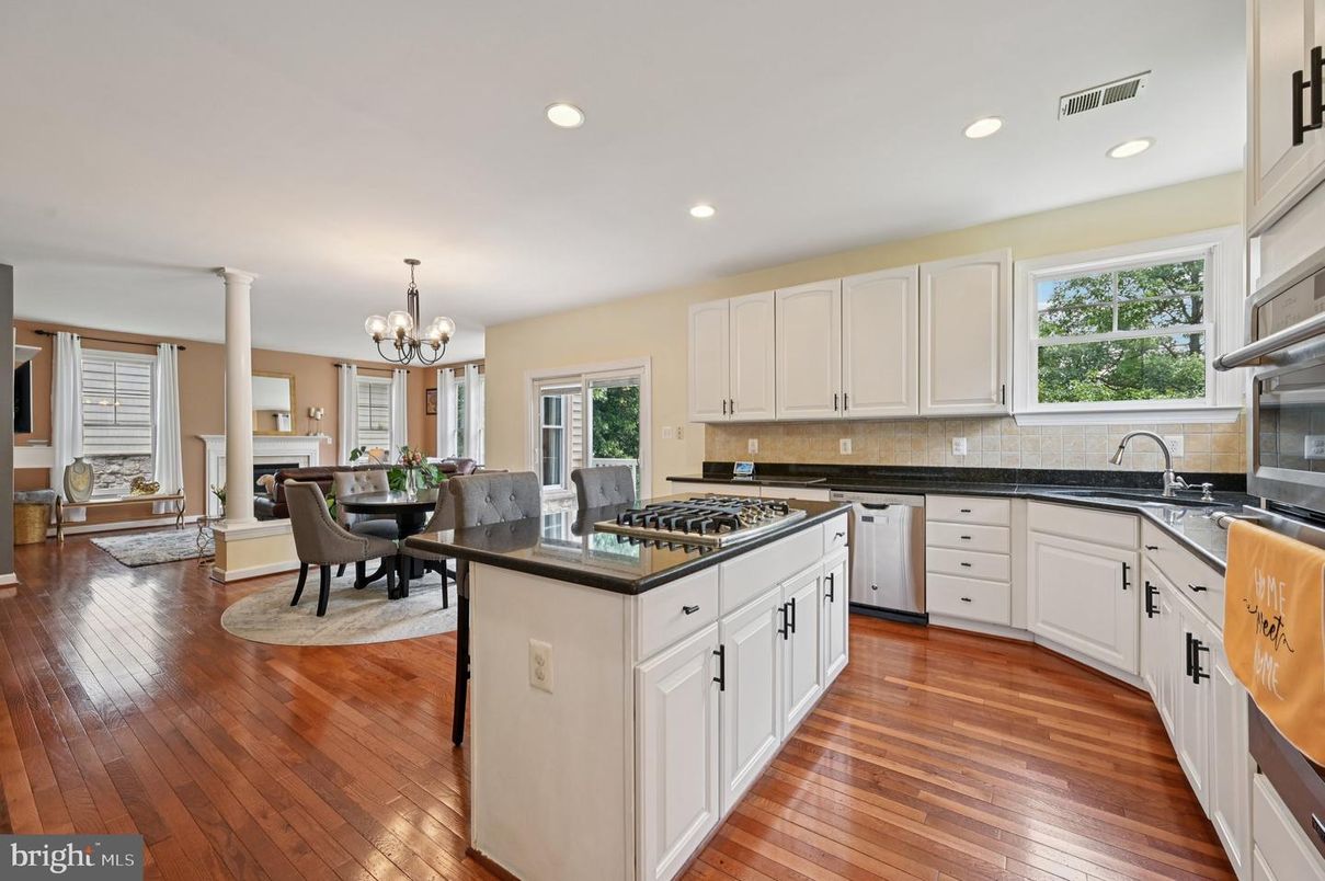 Chandelier, Dining room, Fireplace, Interior, Kitchen, Recessed Lighting, Stainless Steel Appliances, Wood Texture Flooring