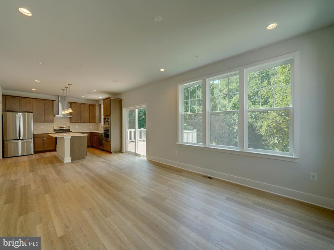 Empty room, Interior, Kitchen, Pendant Lights, Recessed Lighting, Stainless Steel Appliances, Wood Texture Flooring