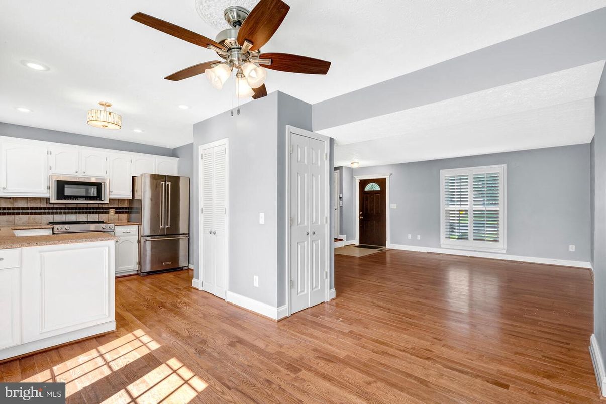 Empty room, Interior, Kitchen, Recessed Lighting, Stainless Steel Appliances, Wood Texture Flooring