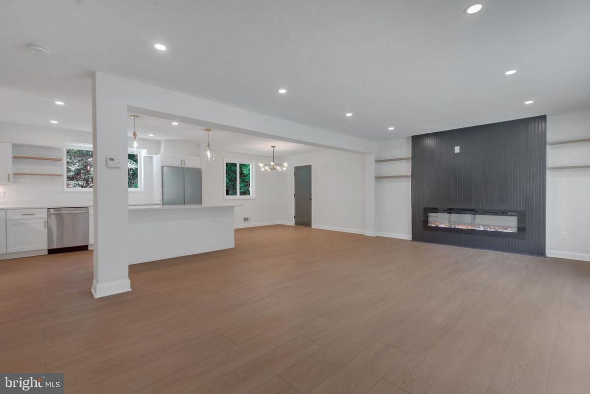 Empty room, Fireplace, Interior, Kitchen, Pendant Lights, Recessed Lighting, Stainless Steel Appliances, Wood Texture Flooring