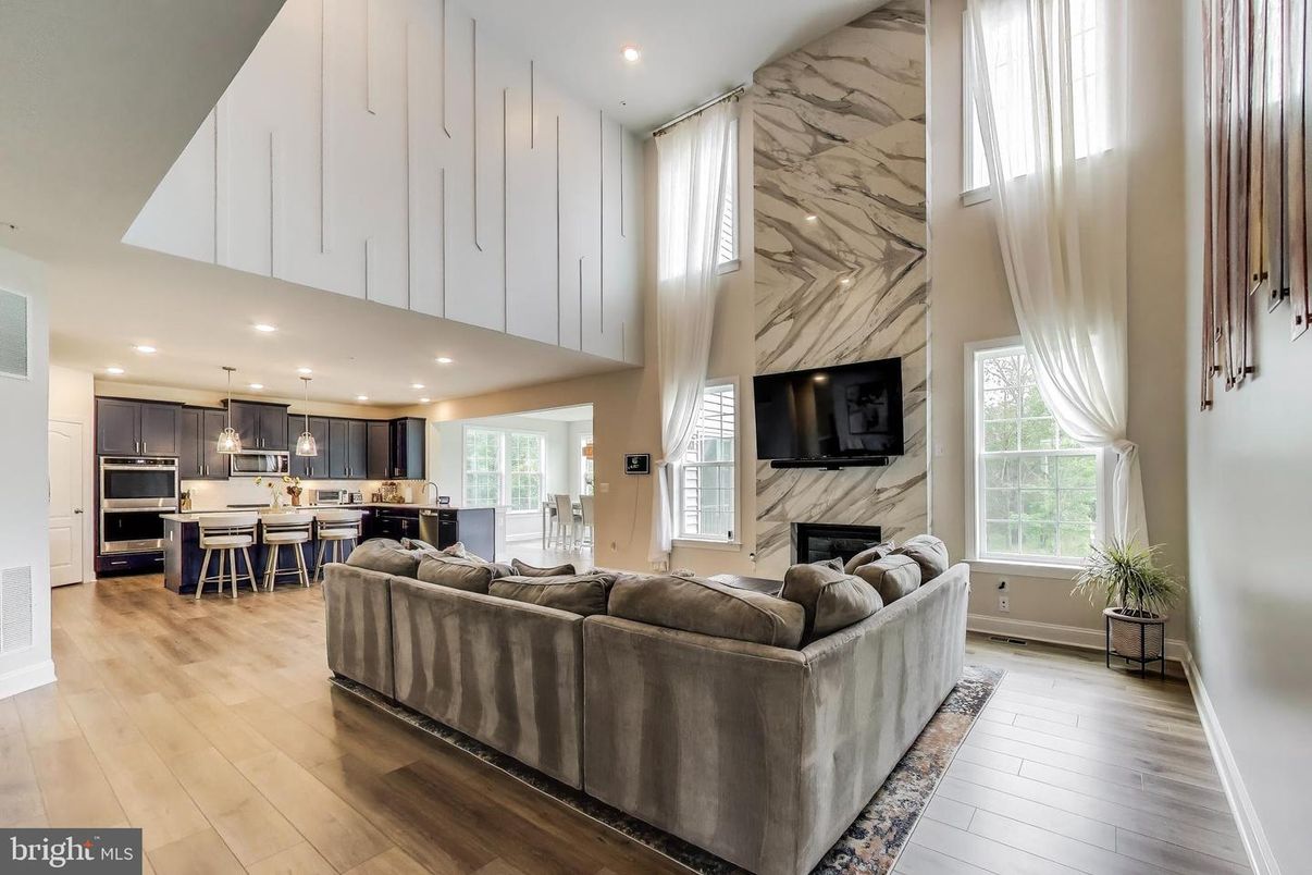 Fireplace, Interior, Kitchen, Living room, Marble Walls, Pendant Lights, Recessed Lighting, Stainless Steel Appliances, Wood Texture Flooring