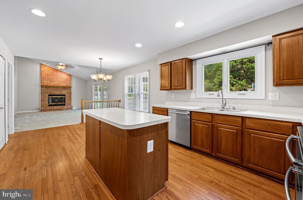 Chandelier, Dining room, Fireplace, Interior, Kitchen, Recessed Lighting, Wood Texture Flooring