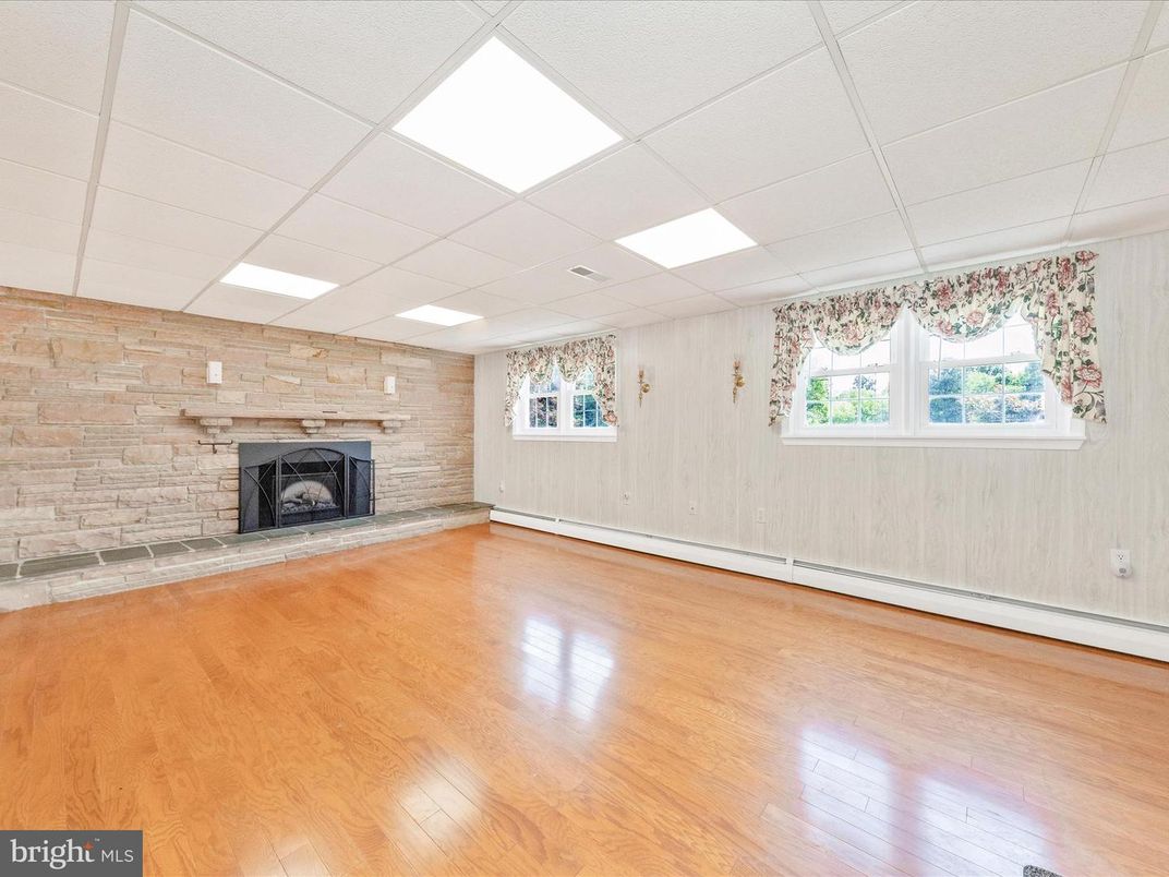 Empty room, Fireplace, Interior, Recessed Lighting, Stone Walls, Wood Texture Flooring