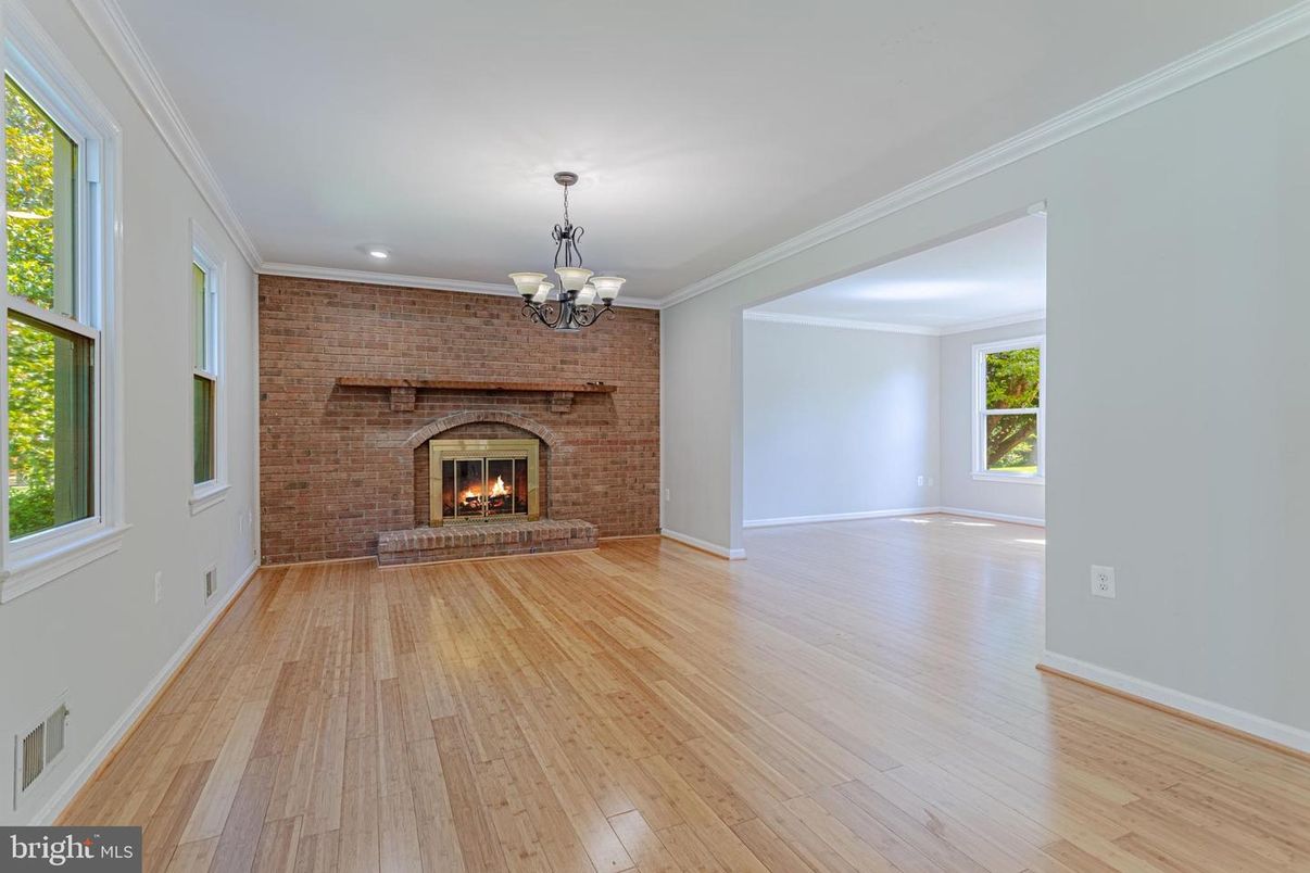 Chandelier, Empty room, Fireplace, Interior, Recessed Lighting, Stone Walls, Wood Texture Flooring