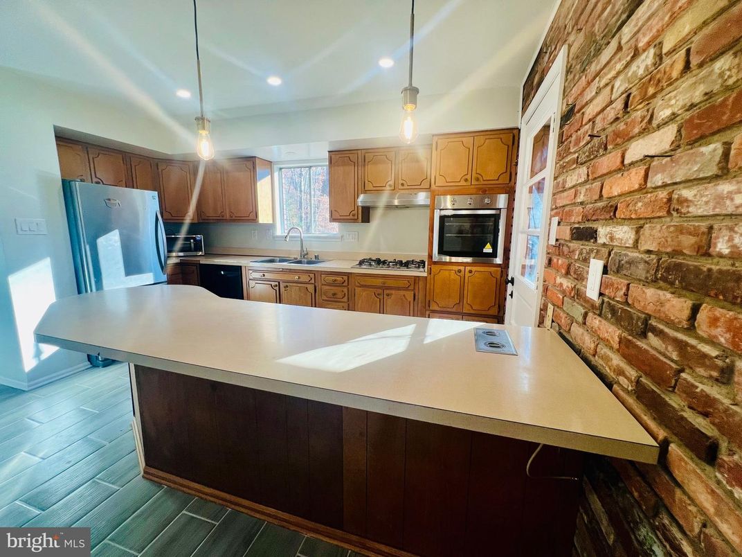 Interior, Kitchen, Pendant Lights, Recessed Lighting, Stainless Steel Appliances, Stone Walls, Wood Texture Flooring