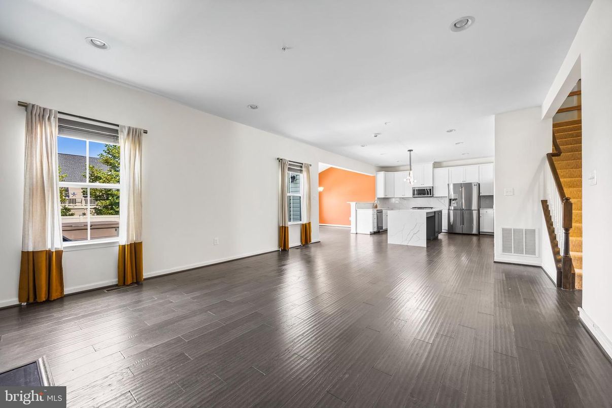 Empty room, Interior, Kitchen, Pendant Lights, Recessed Lighting, Stainless Steel Appliances, Wood Texture Flooring