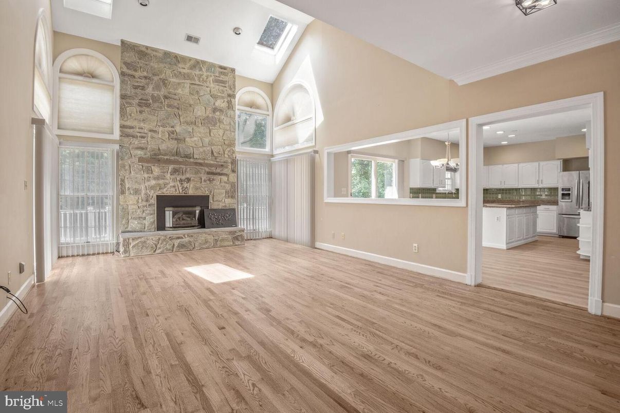 Empty room, Fireplace, Interior, Kitchen, Pendant Lights, Recessed Lighting, Stone Walls, Wood Texture Flooring