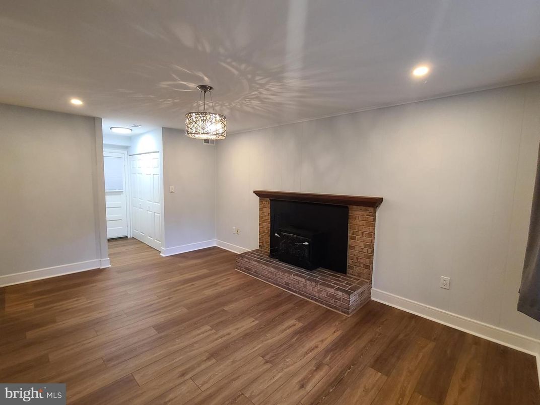 Chandelier, Empty room, Fireplace, Interior, Recessed Lighting, Wood Texture Flooring