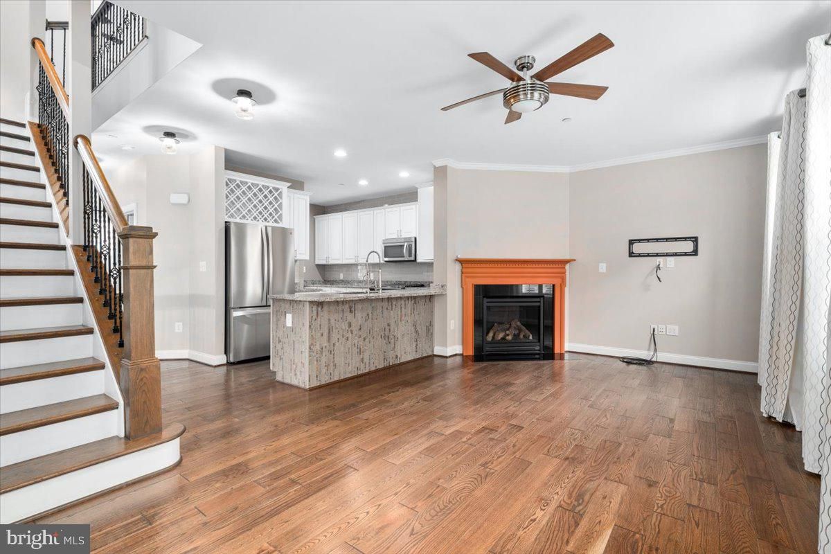 Fireplace, Interior, Kitchen, Recessed Lighting, Stainless Steel Appliances, Wood Texture Flooring
