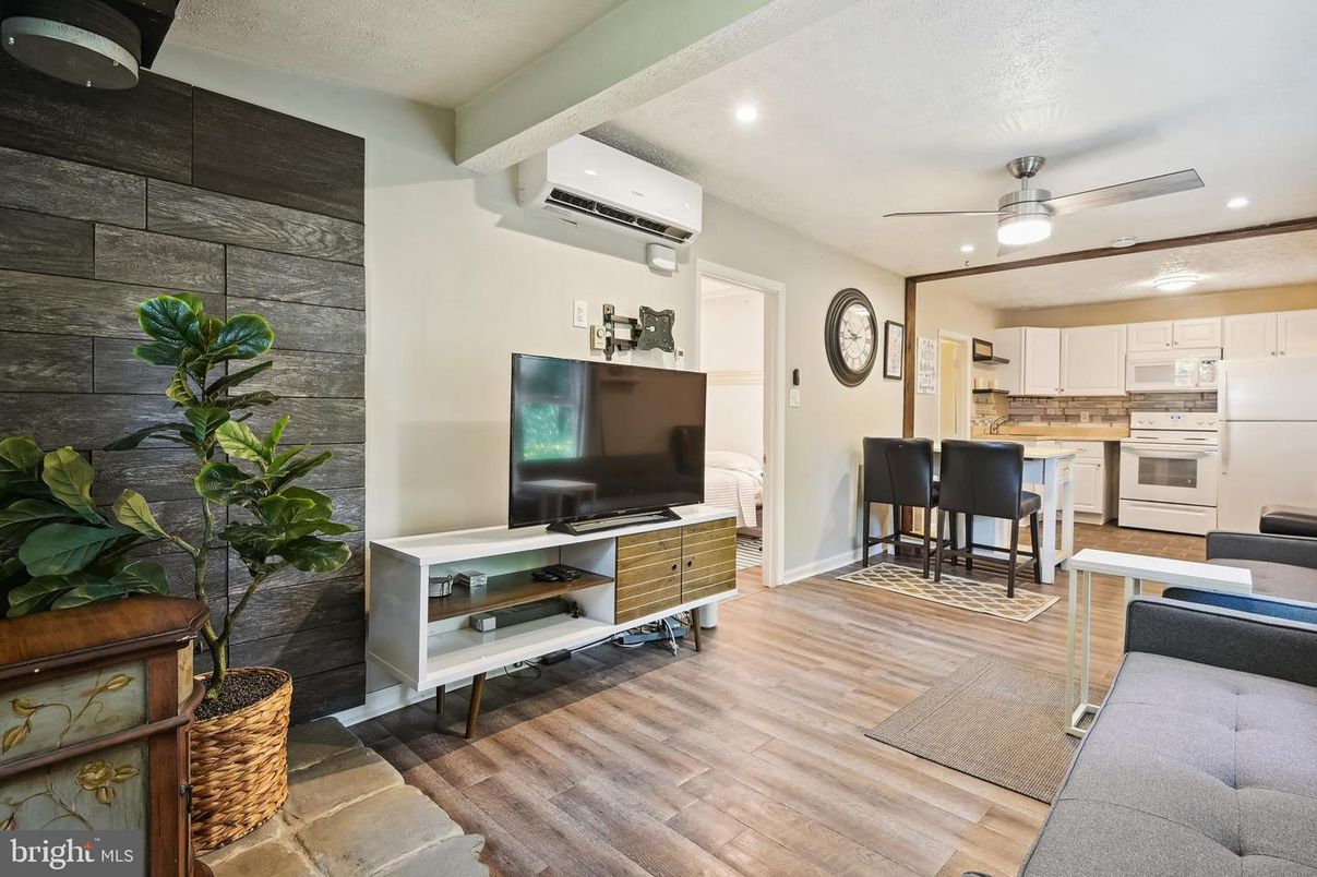 Dining room, Interior, Kitchen, Recessed Lighting, Stainless Steel Appliances, Stone Walls, Wood Texture Flooring
