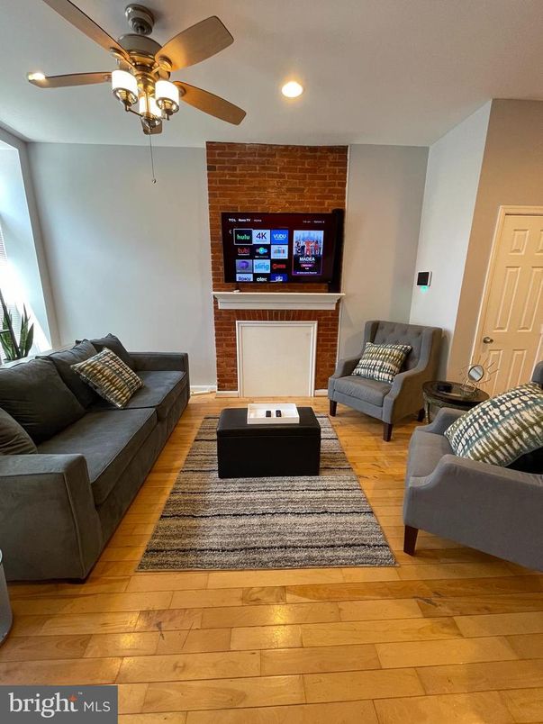 Fireplace, Interior, Living room, Recessed Lighting, Stone Walls, Wood Texture Flooring
