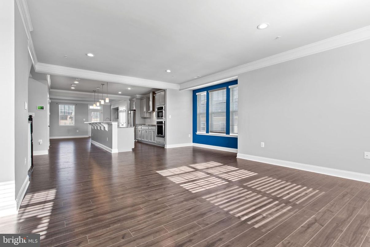 Empty room, Interior, Kitchen, Pendant Lights, Recessed Lighting, Stainless Steel Appliances, Wood Texture Flooring
