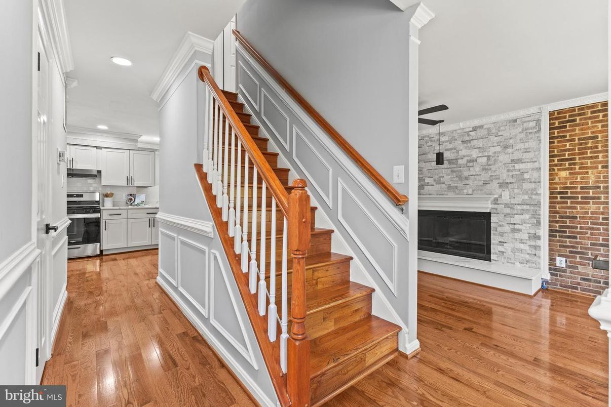 Fireplace, Interior, Kitchen, Recessed Lighting, Stainless Steel Appliances, Stone Walls, Wood Texture Flooring