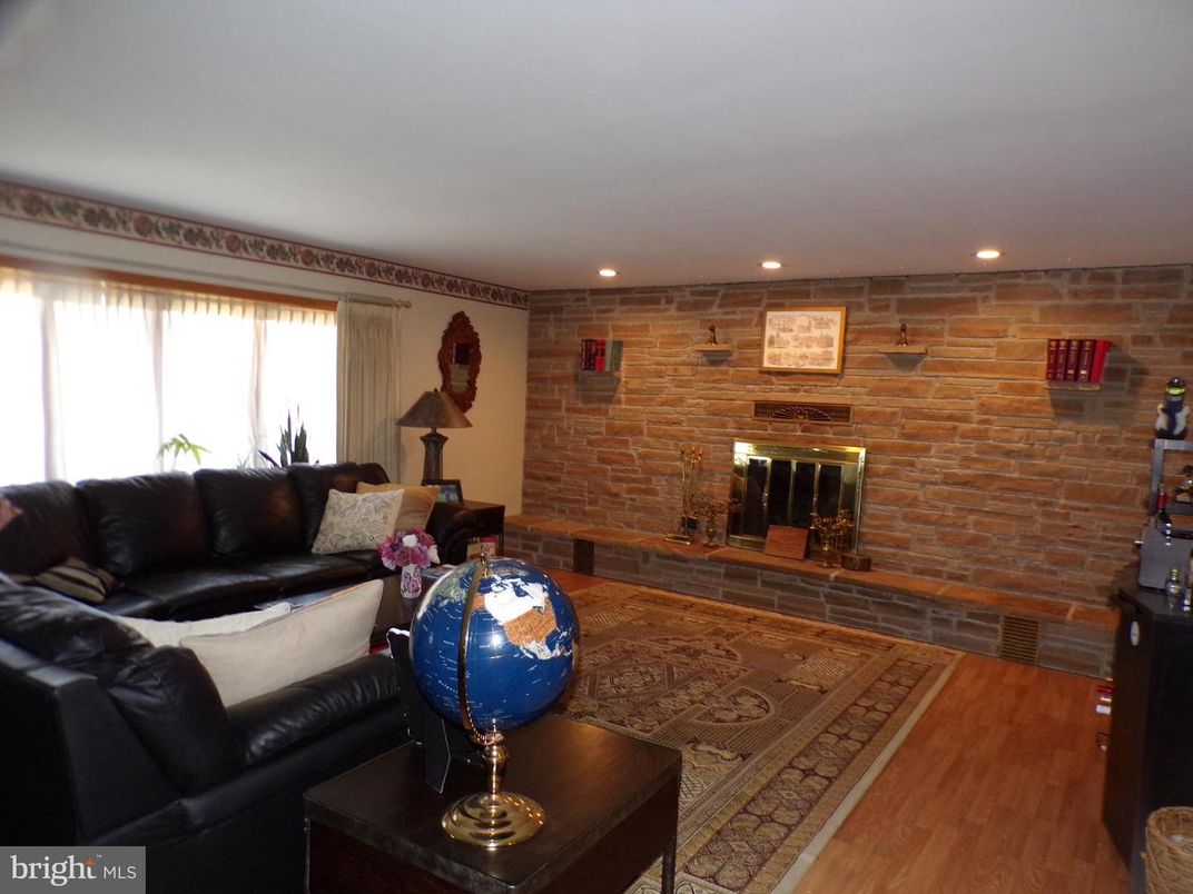 Fireplace, Interior, Living room, Recessed Lighting, Stone Walls, Wood Texture Flooring