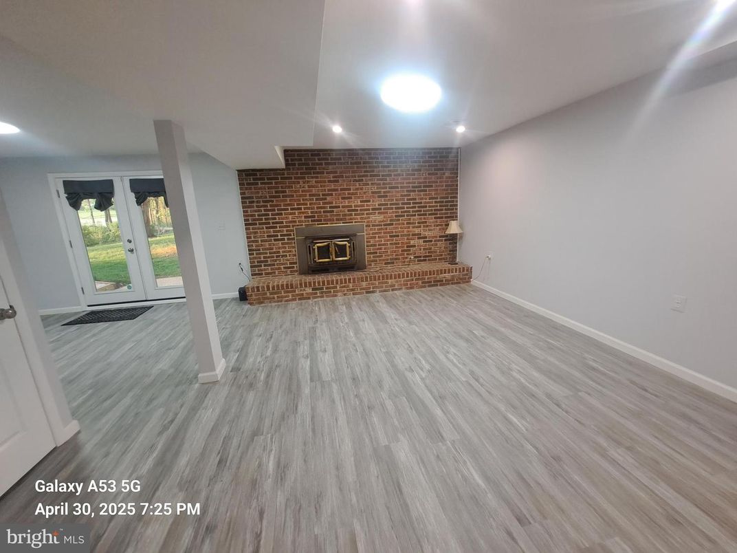Empty room, Fireplace, Interior, Recessed Lighting, Stone Walls, Wood Texture Flooring