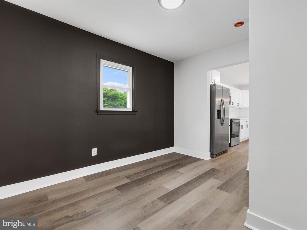 Empty room, Interior, Kitchen, Recessed Lighting, Stainless Steel Appliances, Wood Texture Flooring