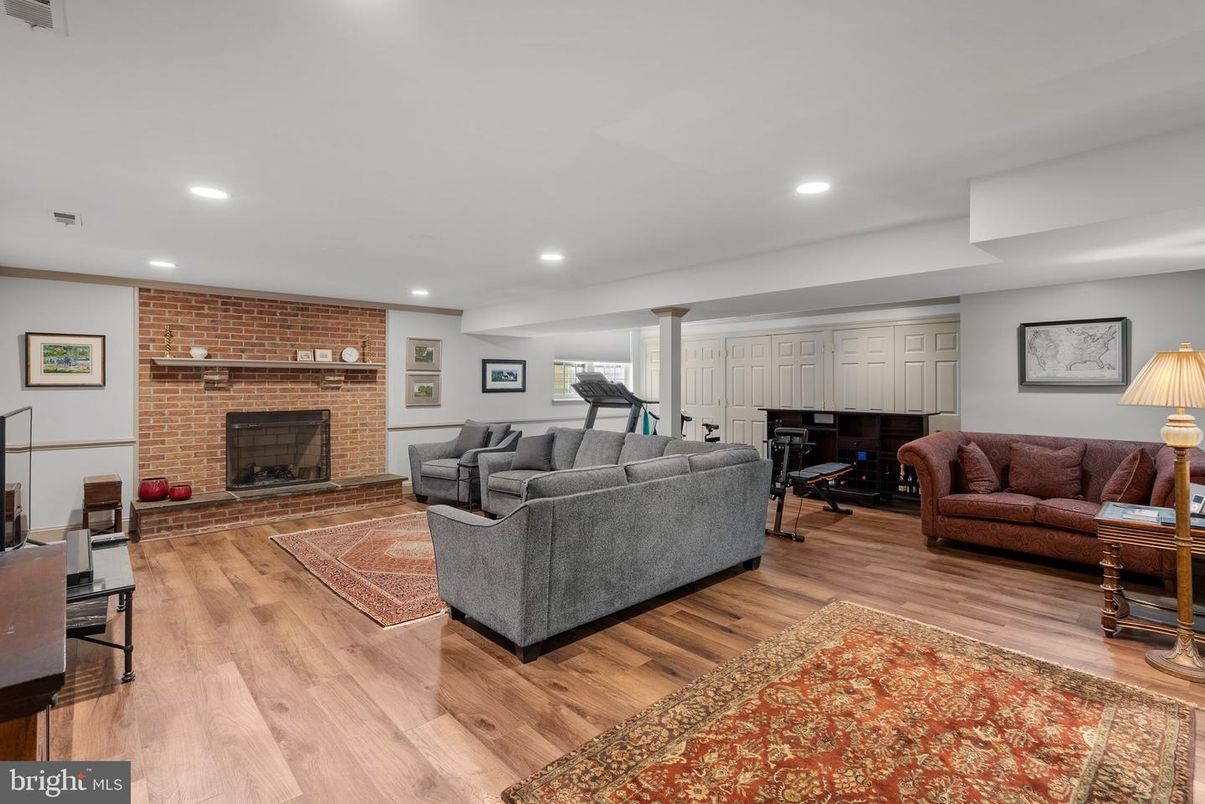 Fireplace, Fitness Equipment, Interior, Living room, Piano, Recessed Lighting, Stone Walls, Wood Texture Flooring
