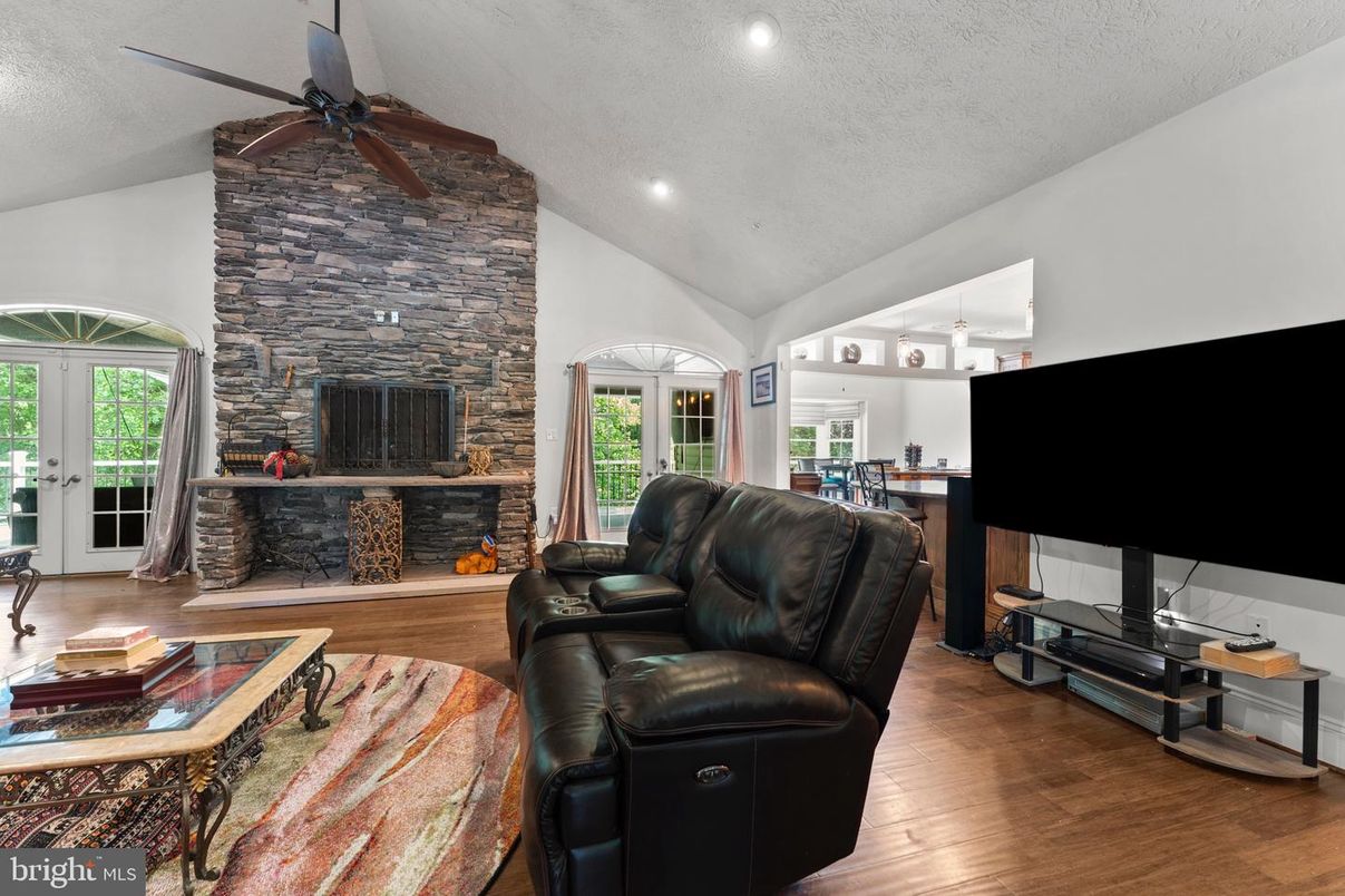 Fireplace, Interior, Living room, Recessed Lighting, Stone Walls, Wood Texture Flooring