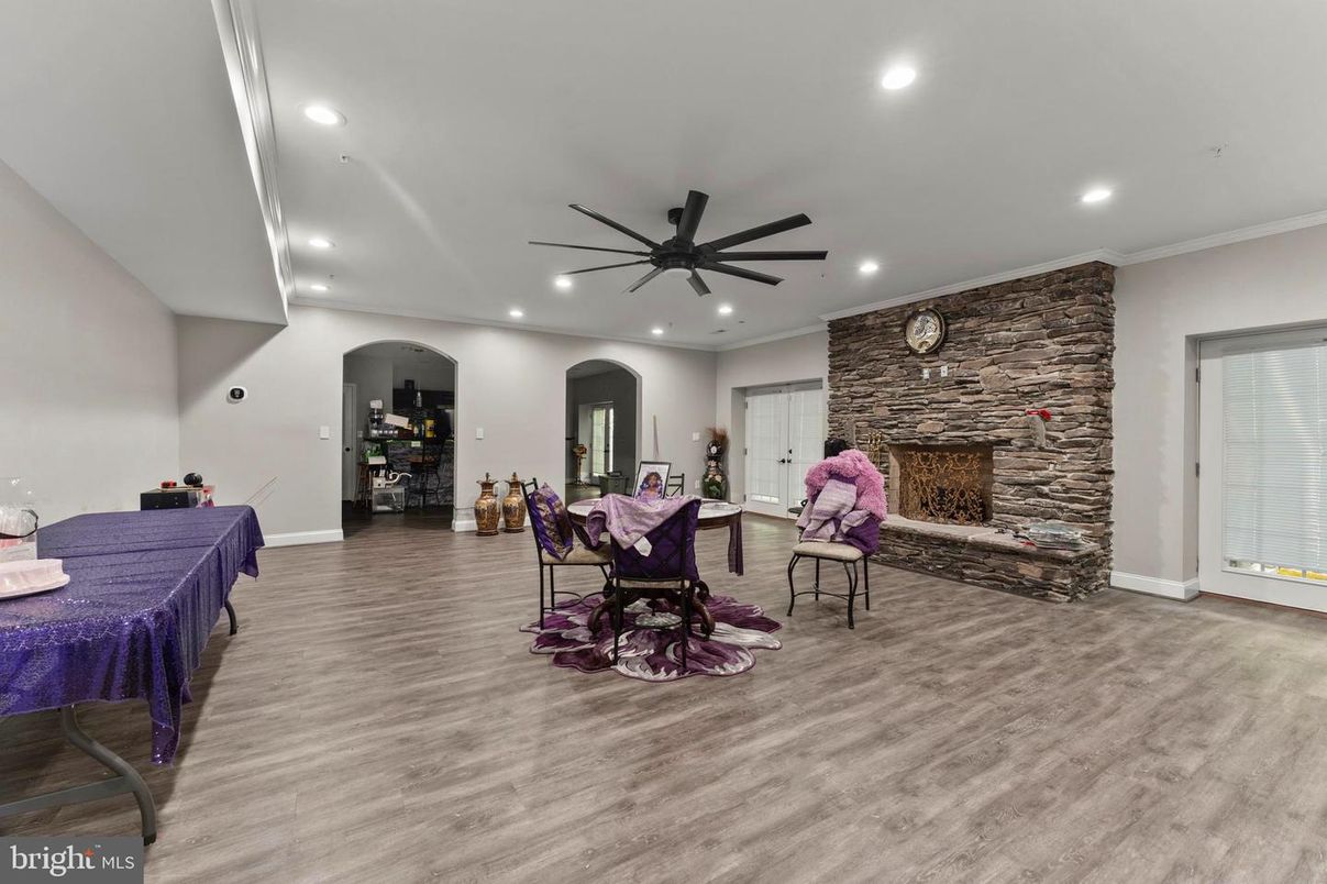 Dining room, Fireplace, Interior, Recessed Lighting, Stone Walls, Wood Texture Flooring