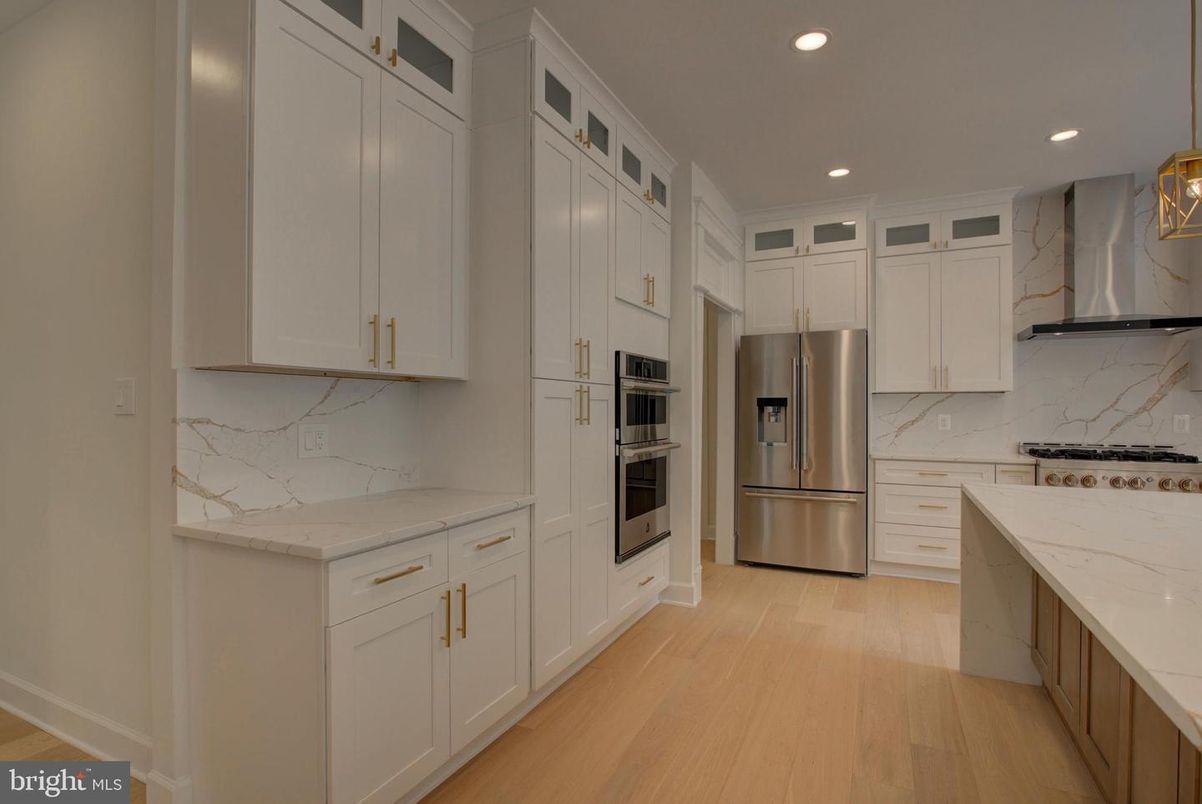 Interior, Kitchen, Marble Walls, Recessed Lighting, Stainless Steel Appliances, Wood Texture Flooring